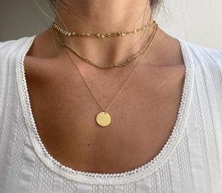 This 4 Layer Coin Necklace is a must-have fashion accessory, perfect for effortlessly elevating any outfit. With its trendy and versatile design, this gold necklace can be worn for any occasion, making it the ideal gift for yourself or a loved one. Add a touch of sophistication and style with its layered coin design. Layered in gold fill this set gives an effortless refined look day or night.